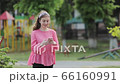 Girl use of smart phone at outdoor. 66160991