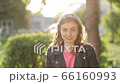 Beautiful girl smiling looking happy cute child having fun in sunny park outdoors. 66160993