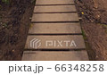 Walking across a wooden footpath in the woods.  A first person view of someone walking across a wooden footpath in the forest 66348258