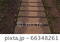 Walking across a wooden footpath in the woods.  A first person view of someone walking across a wooden footpath in the forest 66348261