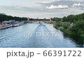 Speedboat floats along the river Seine. Leaving waves of blue water scattering on the sides. The boat is sailing towards the Alexander III bridge. Summer weather, sunny day with not big clouds in the  66391722