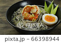 Soba Noodles with Shrimps served Boiled Egg in shoyu soy sauce Soup Japanese Food Fusion Style sprinkle white sesame and seaweed decorate leek sideview 66398944