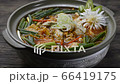 Spicy Oysters Soup with Kimchi Korean Food Style (Guljigae) refreashingly clear in pot decorate with leek sideview 66419175