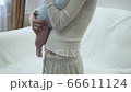View on hands of young mother holds and cradles her baby. 66611124