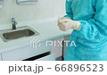 The dentist assistant removes top pair of protective white gloves 66896523