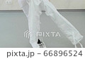 The doctor wears a white protective suit on the legs in the clinic or hospital 66896524