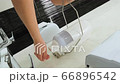 Woman splashes a disinfectant on her hands and washes them. Dutch angle 66896542