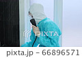 The dentist talks to the receptionist on phone for safe exit of the patient 66896571