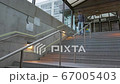young man who climbs the stairs at the station and holds a phone in his hands 67005403