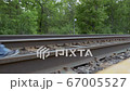young man who is walking on the railway away from the camera 67005527
