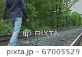 young man who is walking on the railway away from the camera 67005529