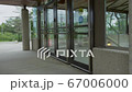 young handsome man opening glass heavy doors and walking into the train station 67006000