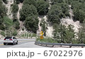 Car on Road Under Hills of Big Bear Mountain, California USA 67022976