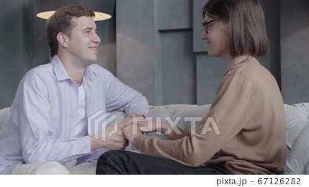 Young brunette Caucasian man holding hands of...の動画素材 [67126282]