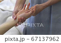 Female hands of a massage therapist do acupressure of hands in a beauty salon Female hands of a massage therapist do acupressure of hands in a beauty salon 67137962