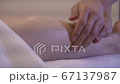 Close up of woman therapist massaging the feet of her patient in spa salon Close up of woman therapist massaging the feet of her patient in spa salon 67137987