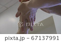 Close up of woman therapist massaging the feet of her patient in spa salon Close up of woman therapist massaging the feet of her patient in spa salon 67137991