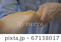 Close up of woman therapist massaging the feet of her patient in spa salon Close up of woman therapist massaging the feet of her patient in spa salon 67138017
