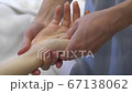 Female hands of a massage therapist do acupressure of hands in a beauty salon Female hands of a massage therapist do acupressure of hands in a beauty salon 67138062