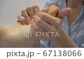 Close up of woman therapist massaging the feet of her patient in spa salon Close up of woman therapist massaging the feet of her patient in spa salon 67138066