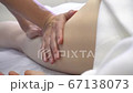 Close up of woman therapist massaging the feet of her patient in spa salon Close up of woman therapist massaging the feet of her patient in spa salon 67138073