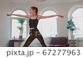 Handsome Athletic Woman Make Body Stretching with Yoga Training.  67277963