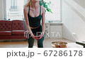 Moving Camera Shot of Pretty Woman Making Yoga Exercise at Home. 67286178