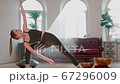 Flexible Yoga Trainer Practising Asana Exercises at Home. Relaxed and Healthy. 67296009