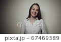 Young business woman over grey background 67469389