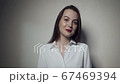 Young business woman over grey background 67469394