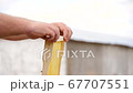 Empty Honeycomb Frame in the Beekeeper's Hands 67707551