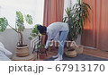 Young african american woman watering...の動画素材 [67913170]