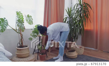 Young african american woman watering...の動画素材