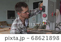 Band-saw . Woodworking. A young carpenter works in his private workshop. 68621898