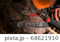 Closeup circular electric saw slow motion footage with warm artificial lighting frame. Woodworking tools. 68621910