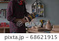 Young master carpenter in the process of working in his carpentry workshop. 68621915