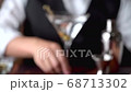 bartender serving martini in glass at bar 68713302