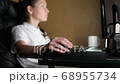 Girl working at night at a computer. Selective focus on the mouse. 68955734