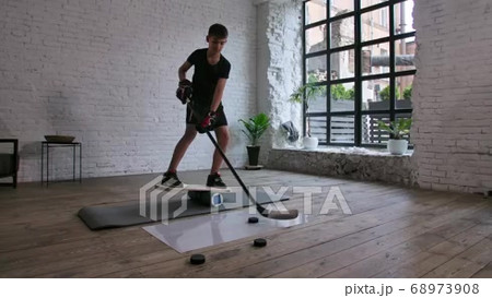 A cute boy hockey player stands on a balance...の動画素材