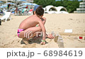 Kids Playing in Sand on Seaside 68984619