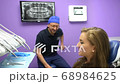 Dentist Welcoming a Patient 68984625
