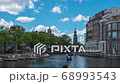 Amsterdam cityscape with view of canal and church time lapse. 68993543