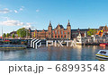 Amsterdam city skyline with Centraal Station in Amsterdam, Netherlands. 68993548