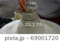 hands working clay on potter's wheel, Lampang in Thailand 69001720