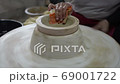 hands working clay on potter's wheel, Lampang in Thailand 69001722