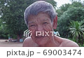 Slow motion smiling Asian poor old worker in countryside. 69003474