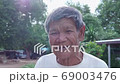 Slow motion smiling Asian poor old worker in countryside. 69003476