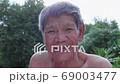 Slow motion smiling Asian poor old worker in countryside. 69003477