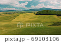 Beautiful and miraculous colors of green spring panorama landscape of Tuscany, Italy. Sunny morning near Pienza. Aerial view  69103106