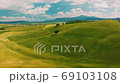 Beautiful and miraculous colors of green spring panorama landscape of Tuscany, Italy. Sunny morning near Pienza. Aerial view  69103108